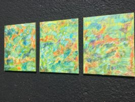 A group of three paintings with a mix of yellows, greens, oranges and purples in a modern style.