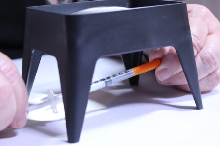 Magnifier with blood glucose meter Using a magnifier to help read the markings on a syringe