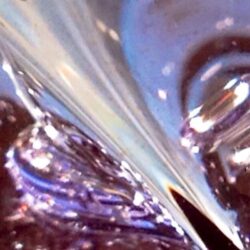 Digital photograph showing light playing off liquid or metallic shapes