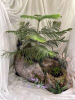 Planter made from Styrofoam and drywall mud made to look like a natural rock formation.