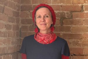 debbie rasmussen standing in front of a brick wall